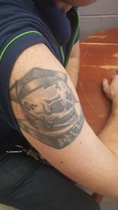 Peter Laub, English teacher at GM, has a tattoo on his right arm of a skeleton with a graduation cap. The skeleton sits on a book that is entitled “The Future is Unwritten.” He got the tattoo when he went back to Ohio State University to get his masters degree in education. (Photo credit: Arjun Narain)