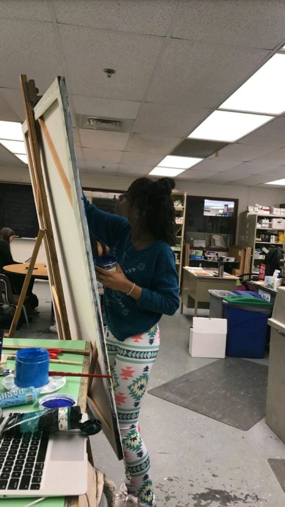 Essence creating a painting in the art room.