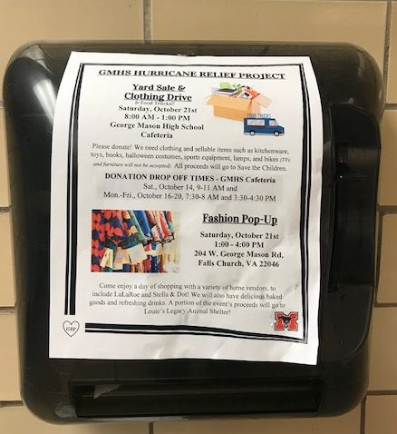 A flyer advertising the Hurricane Relief efforts covers a paper towel dispenser