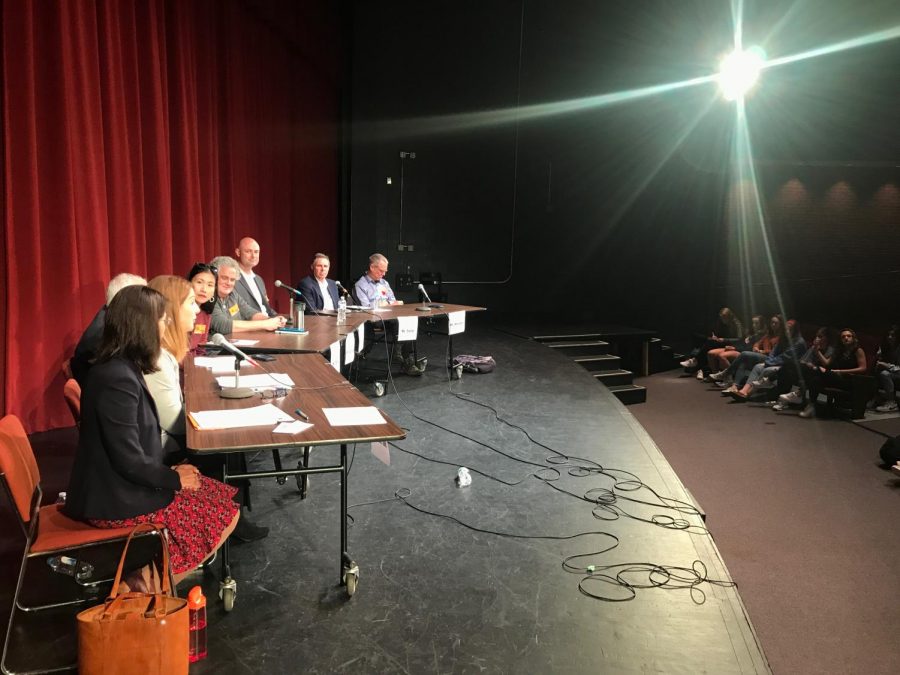 The candidates running for City Council and School Board sit in chairs on stage while the audience watches. The City Council and School Board elections are on November 5th. (Photo by Sam Mostow) 