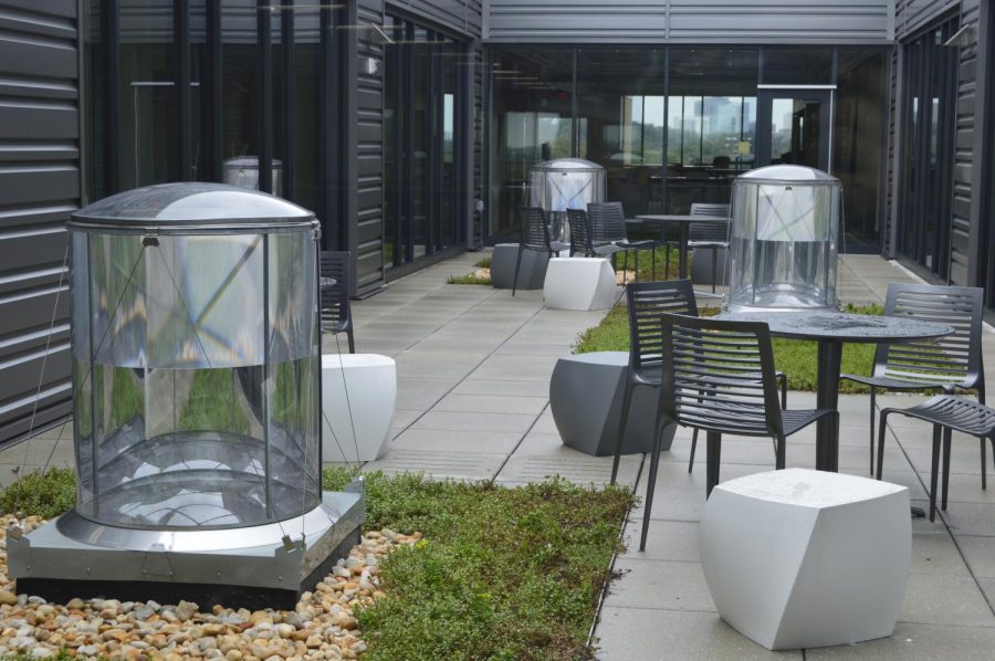 Picture of the reflection garden on the fifth floor. The cylinders in the garden are used to light up the open area on the third and fourth floors instead of artificial lighting.