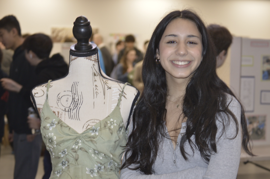 Chase Ehrlich smiles for the camera next to her project, which was a homemade dress (Photo by Kaylah Curley)