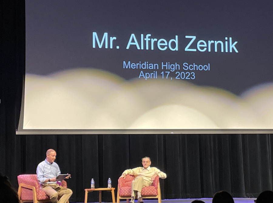 Jared Peet, one of Meridian’s history teachers, asks Mr. Zernik questions about his childhood experiences. (Photo by Tessa Kassoff) 
