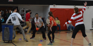 Principal in action with red gatorball during a game at pep rally