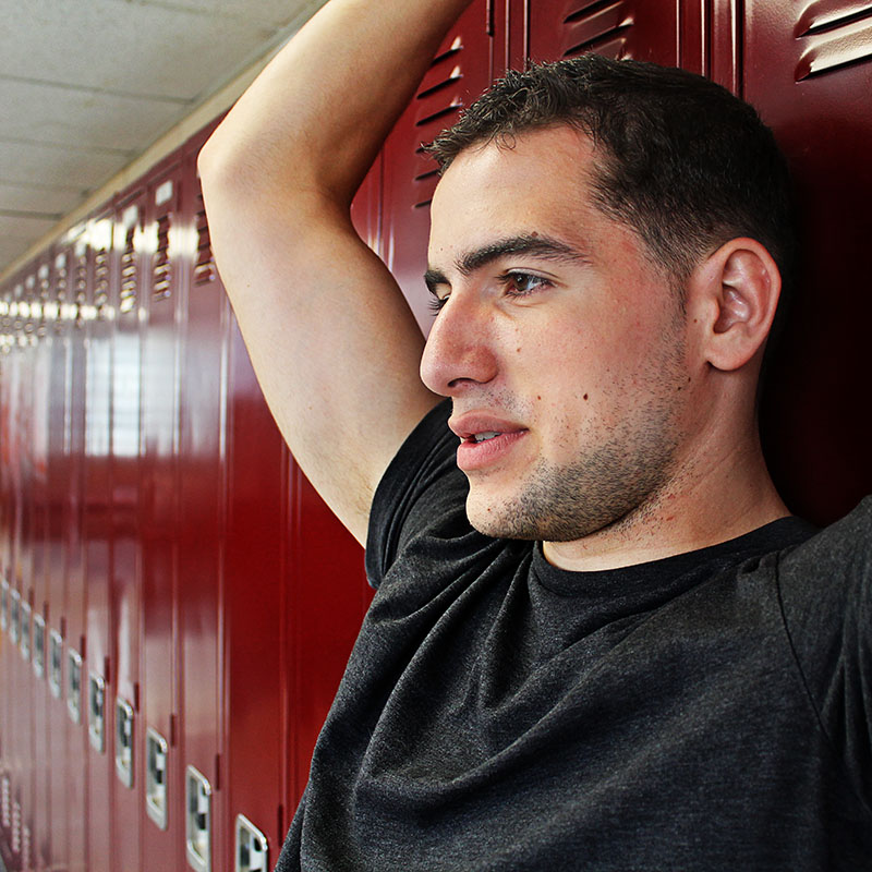 Student leaning against lockers