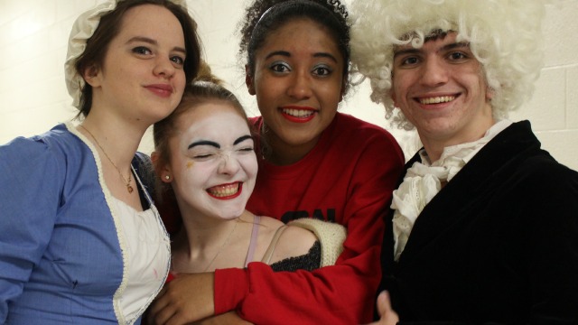 Four students in their play costumes