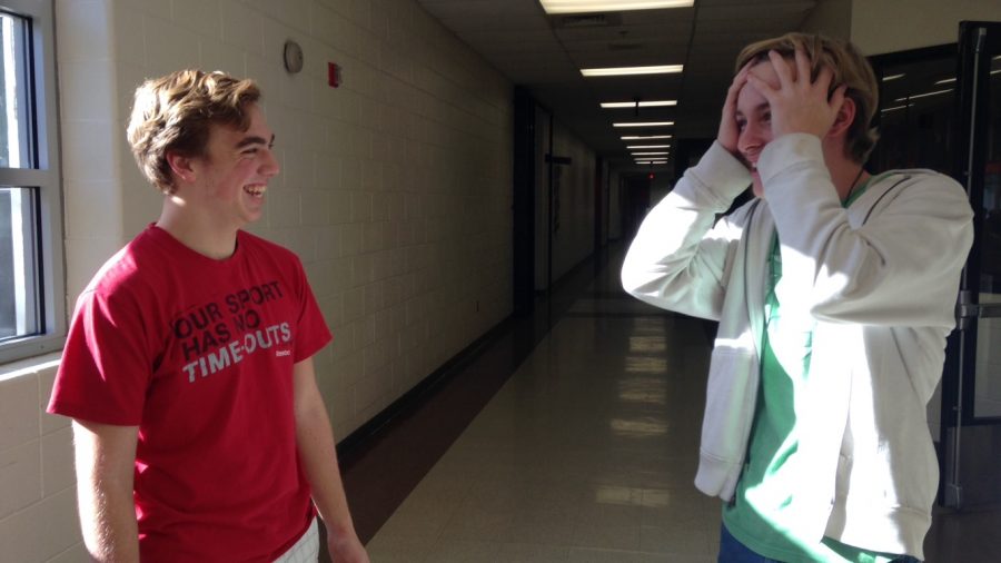 Two students laughing in the hallway
