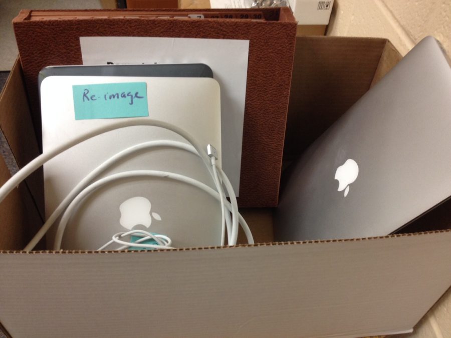 Box of laptops and chargers