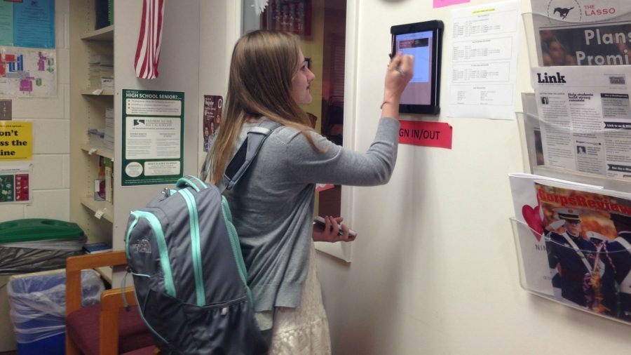 Student signing out of counseling office on an iPad