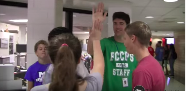 People+high-fiving+in+the+hallway
