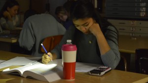 A student does math at a desk