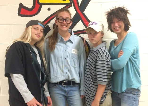 Four students pose for a photo in costume