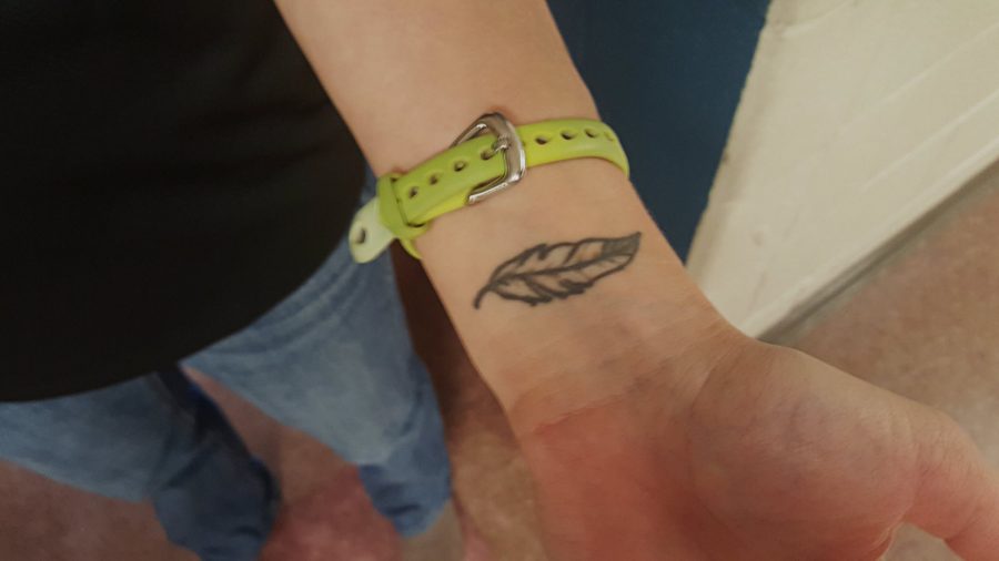 Ms. Rebecca Eisenberg, History and AP government teacher, has a tattoo of a feather on her left wrist. It represents the symbolism of a bird. (Photo credit: Arjun Narain)