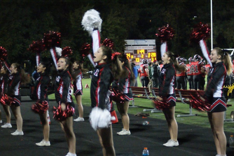 The Mason varsity cheer team is seen cheering during the October 16th homecoming game. “We had a lot of fun this season,” said junior Maddie Rands. (Photo Courtesy of Carol Sly)