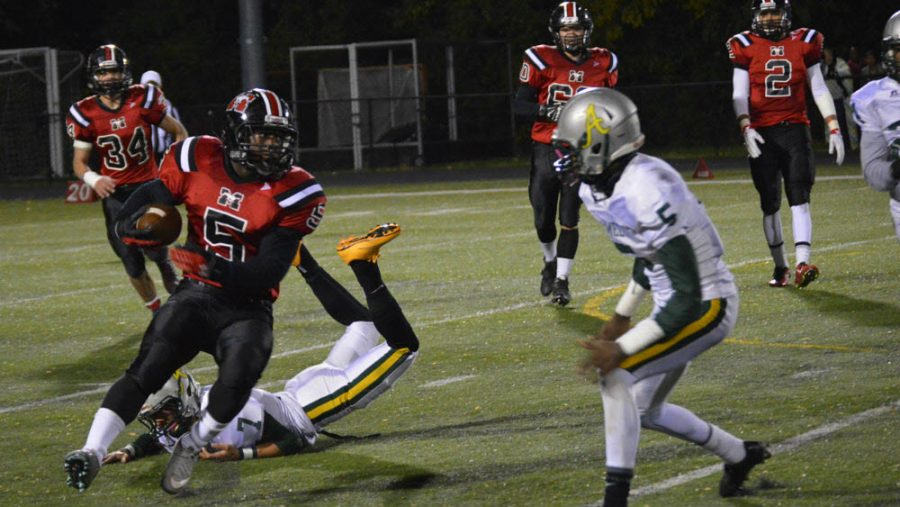 Senior running back D’Montae Noble makes a vital run for Mason offense. The team won the first post-season game against Amelia County at home with a score of 42-28. (Photo credit: Kate Karstens)