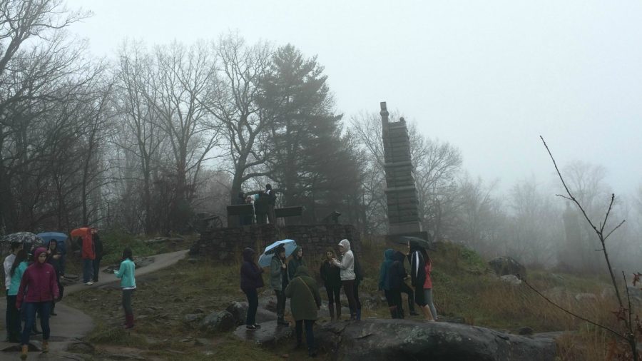 Photo 2: Students take pictures and explore Little Round Top despite the pouring rain. (Photo Credit: Allyson Kryk).