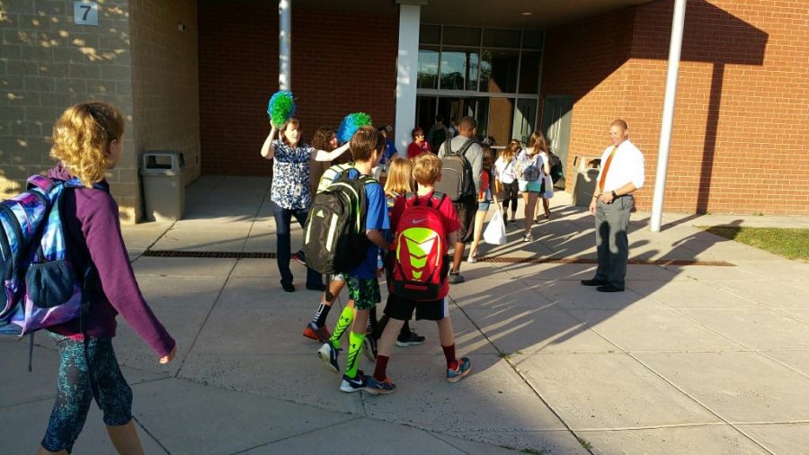 Students from MEHMS walk off their morning buses into school. Typically the middle and high school have started later, but with many moving parts interacting with both schools it will be easier for both schools to be on the same bell schedule. (Photo courtesy of Falls Church City Public Schools). 