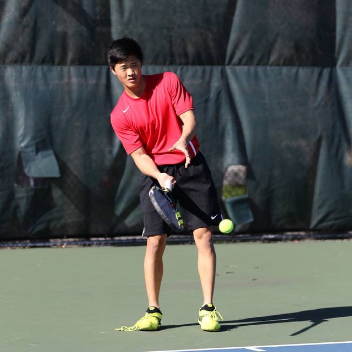 Freshman Chris Kim hitting a forehand before a home tennis match. His first season with the boys tennis team proved successful with a 10-3 singles record, a 12-1 doubles record, and a qualification in the 2A VHSL State Championship. His loss in the semi-final game serves as an acknowledgment to his hard work as well as a goal to surpass in the coming three years.