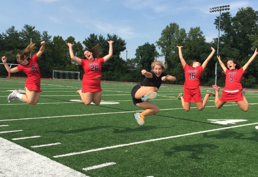 Mason Field Hockey players leap in the air for a photo