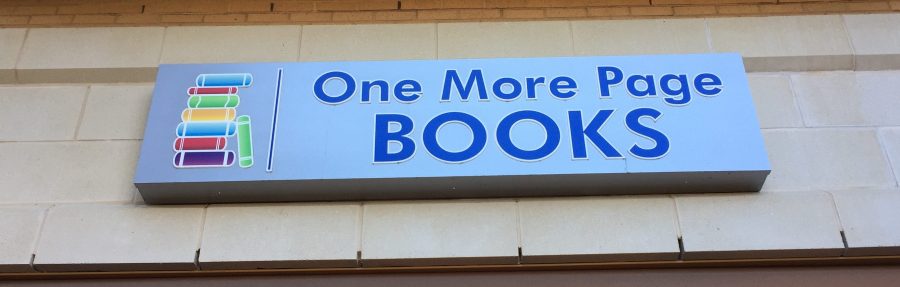 The sign for One More Page Book Store outside of the store.