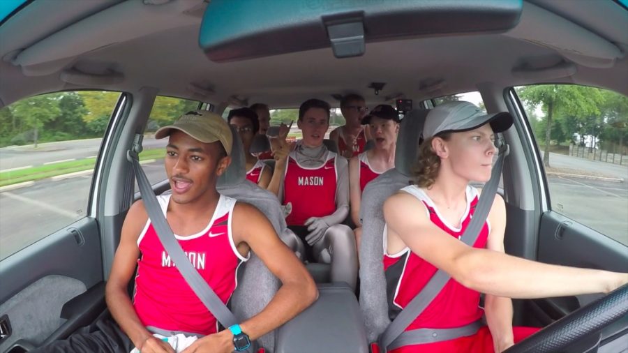 The boys cross country team driving in a car while jamming to Uptown Funk