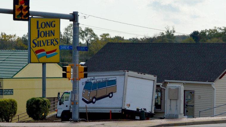 The former Long John Silvers, with its signs still there, and a Mikes Deli truck in front of it.