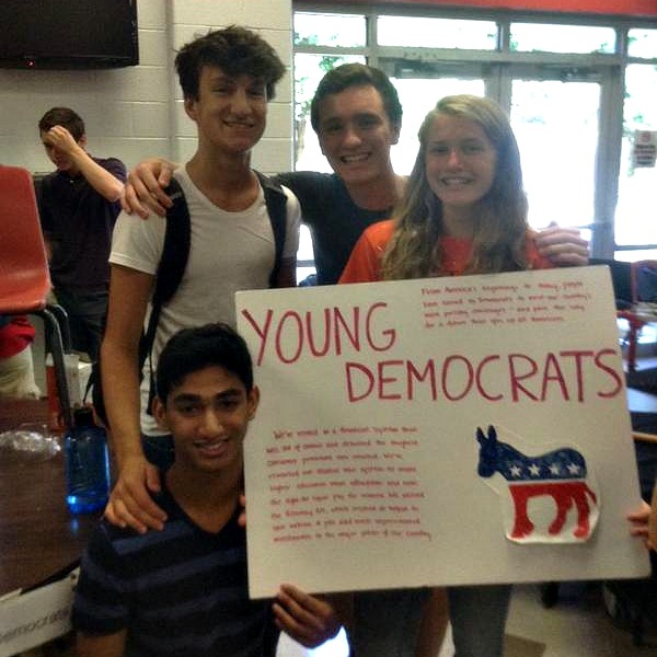 Students hold a young Democrats poster