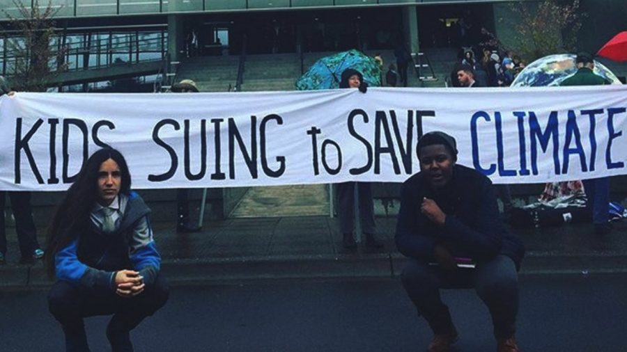Students with banner reading kids suing to save climate