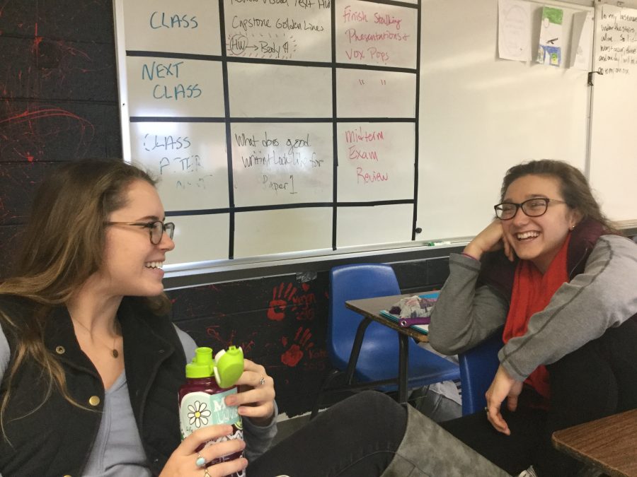 Korinne and Sydney talking in a classroom