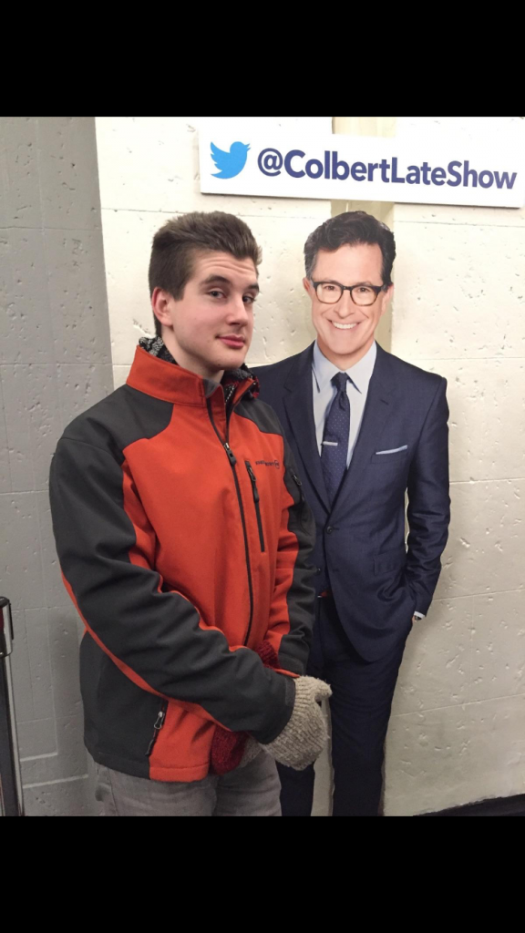 Erik Boesen posing with a cutout of Stephen Colbert after he viewed the Late Show.
