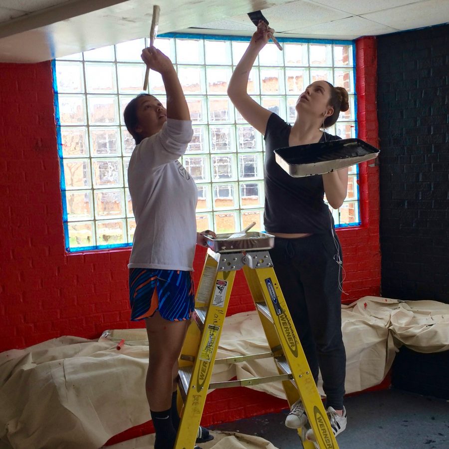 A photo of students painting the senior alcove