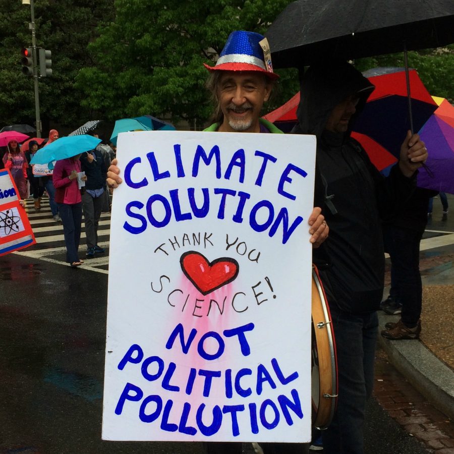 A protestor holding a climate change sign.