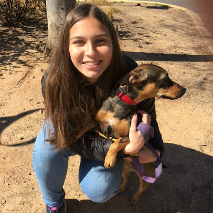 Freshman Isabel Davis, pictured with a dog she volunteers with.