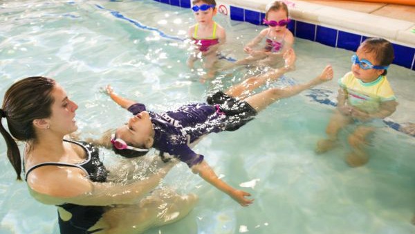 Kids learn to swim at Kids First Swim School