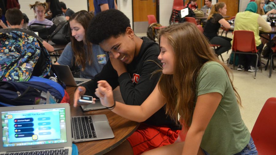 Freshmen Johnny Goodwin (left)and Claire O’Hanlon (right) laugh as the play a game. (Photo by Sierra Sulc)