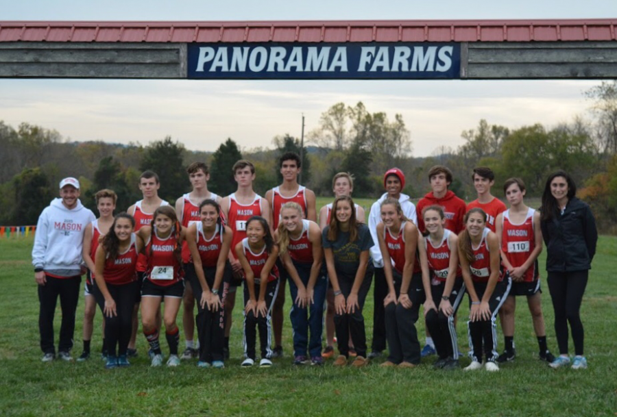 Cross country team poses for a photo at the finish line.