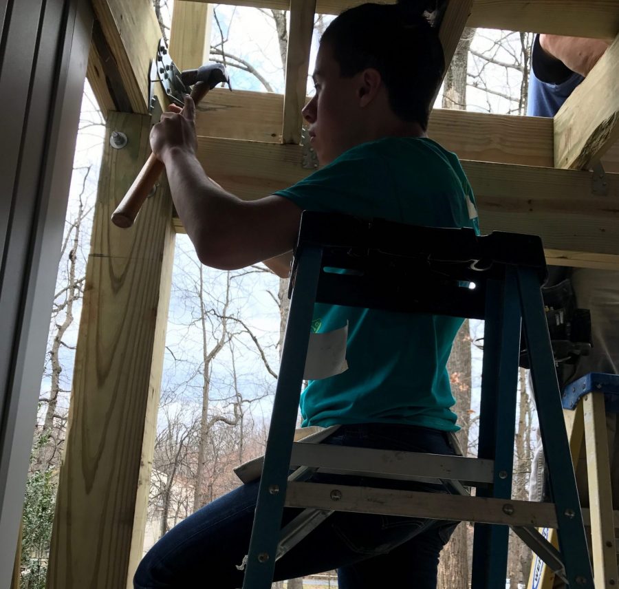 Senior Matthew Freud working on a deck in a Habitat for Humanity build last year.