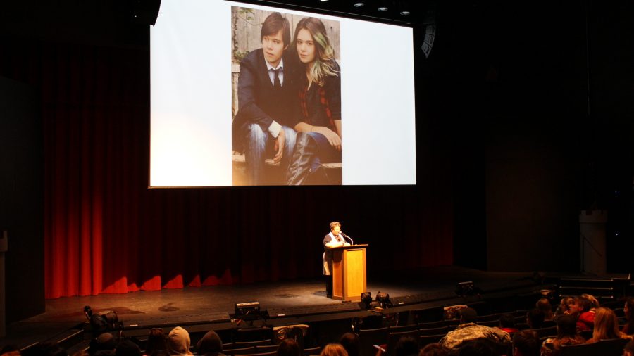 Amy Ellis Nutt speaks to students in the auditorium. Behind her is a photo of Nicole (right) and her twin brother Jonas. (Photo by Zollie Brown)
