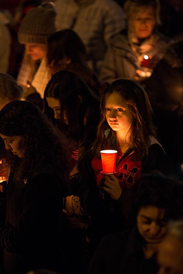 Members of the Falls Church community gathering on Monday, February 24, in front of George Mason. With candles, hearts, and respect for the Florida victims, they mourn the loss of the 17 lives and express the need for increased gun control. (Photo by Tenzin Namagyel)