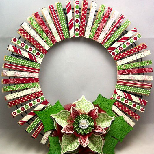 A wreath with christmas-themed clothespins around it.