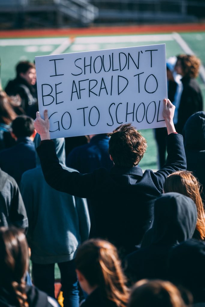 A student holding up a sign.  (Photo by Tenzin Namgyel)

