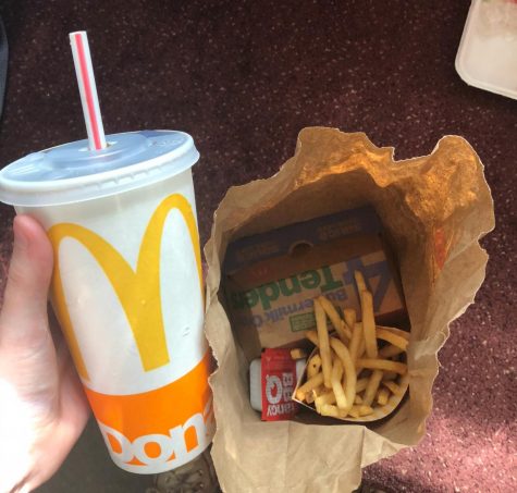 McDonalds cup and paper bag with french fries in it