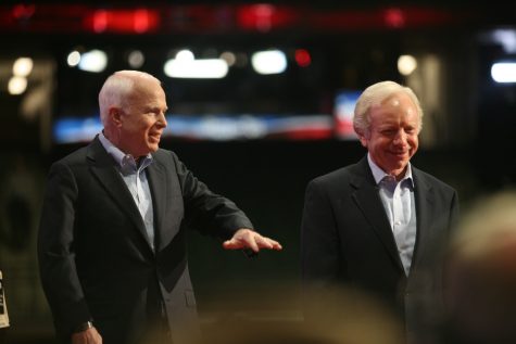 Two men, John McCain and Joe Lieberman, walking.