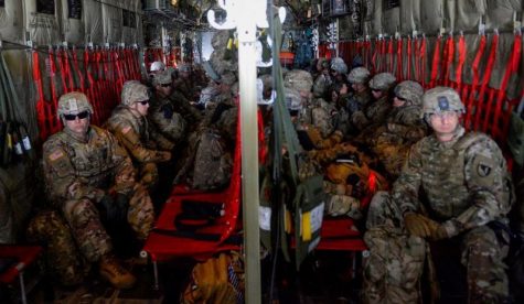 US Soldiers from the 89th Military Police Brigade and 41st Engineering Company in a transport plane.