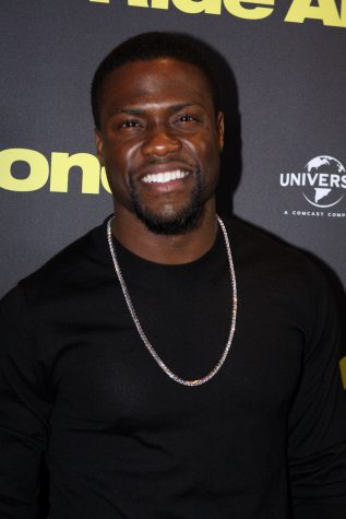 Comedian Kevin Hart smiles for a photograph.