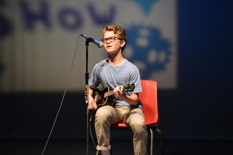 Freshman Henry Boland performs “Glass Box an original song written by him about the world outside of Falls Church.