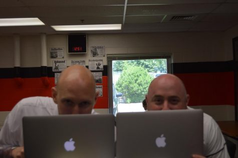 two men behind computers