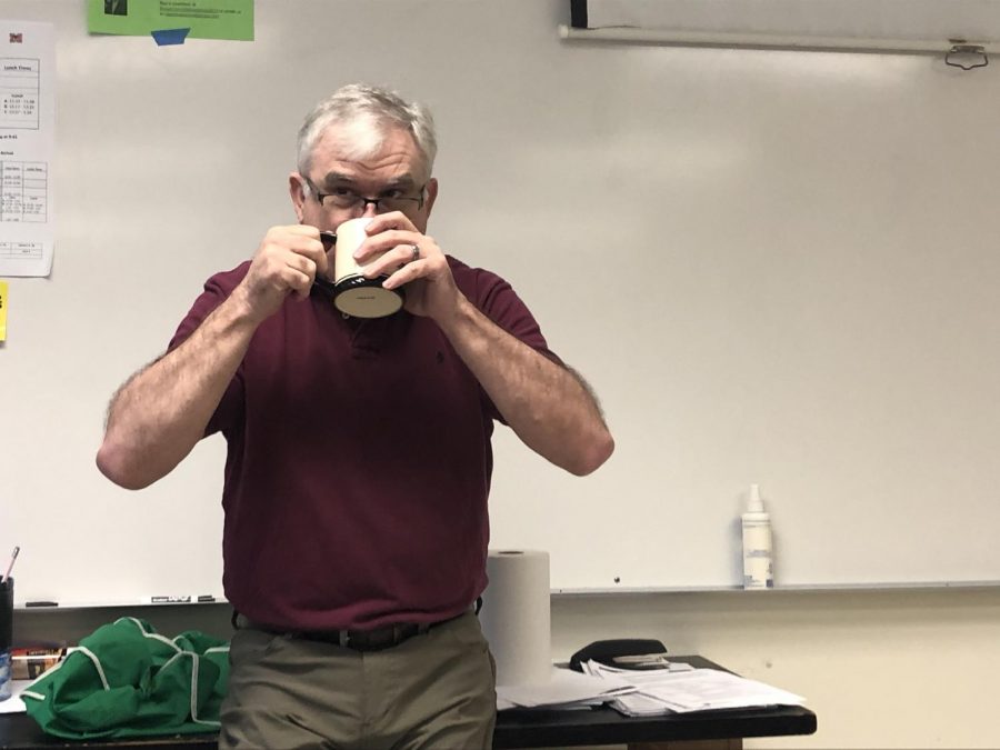 Man drinking from a mug.