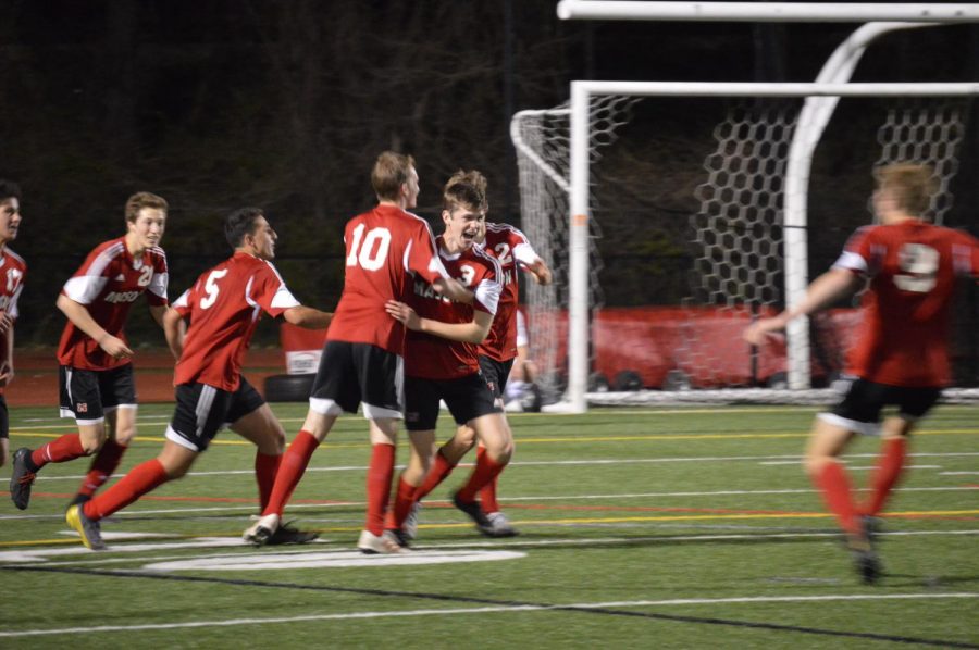  The team celebrates after Henry Brorsen (11) scores the game-winning goal in the final minute of the game.