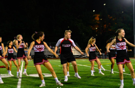 The cheer team dances.